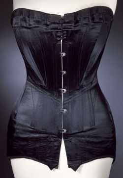 historicalcorsets:  Corset of boned black satin with metal fastenings,