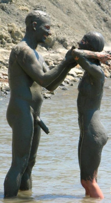 mixedgendernudity:  Nudist couple plays with mud while being
