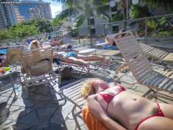 proudofherbush:  just tanning at a public pool in her microbikini