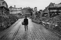 A man walks through the destroyed city looking for food, 1945.