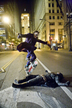   Heath Ledger as the Joker skate boarding over Christian Bale