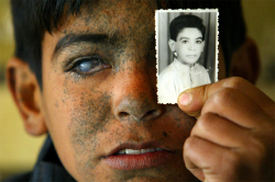  Iraqi boy, Ayad Brissam Karim, shows a picture of himself taken