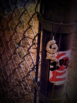 my idea logo chain around a defaced fence post