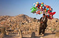 ghazalaa:  Man selling toys in a cemetery. Kabul, Afghanistan