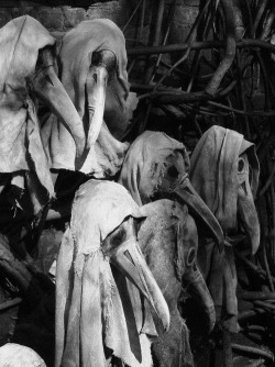 congenitaldisease:  Masks worn by doctors during the Plague - The protective suit of the plague doctor consisted of a heavy fabric overcoat that was waxed, a mask with glass eye openings and a cone nose shaped like a beak to hold scented substances and
