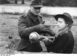 error888:  A German woman being shown how to use a Panzerfaust, Berlin March 1945.[800x579] : HistoryPorn 