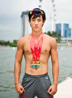 “TeamSG Canoeist Brandon Ooi Wei Cheng poses with his silver and gold medals“Source: Team Singapore