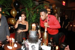 Adrienne takes a pic while loso makes a wish and blows out the candles