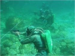 gunrunnerhell:  Water War Russian troops with their specially designed firearms designed to be fired underwater. The pistol is the SPP-1. You can see the distinct silhouette of the APS Underwater Rifle in the background with its massive magazine.