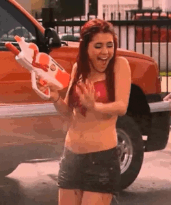 Ariana Grande getting sprayed all over her stomach.