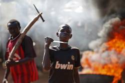 politics-war:  A boy brandishes a knife as he stands in front of a barricade during a demonstration after French troops opened fire at protesters blocking a road in Bambari, Central African Republic