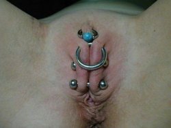 pussymodsgaloreShe has a hairless pussy with a HCH piercing with a decorative ring, additionally pierced outer labia with a ring and two barbells. Chastity piercing.
