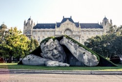 sixpenceee:   Hungarian artist Ervin Herve-Loranth is responsible the enormous sculpture, entitled ‘Feltépve’ which translates as ‘ripped up’ or ‘pop up’. The gigantic man appears to be emerging from underneath a blanket of grass. It was