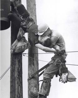 historicaltimes:&ldquo;The Kiss of Life&rdquo;: A utility worker, J.D. Thompson, giving mouth-to-mouth to co-worker Randall G. Champion after he contacted a high voltage wire -Full details in comments- cobb__salad: This photo shows two power linemen,