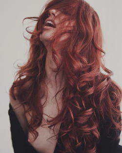 templeofginger:  Moaning redhead with long curly hair and her top falling off.
