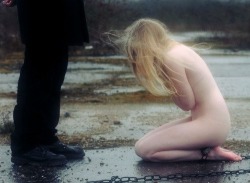 sweetestsimplicity:  chainedtomyconsole:  This is one of the most beautiful pictures I’ve ever seen.. The wind blowing, her chill.. Her pale skin versus his dark pants. The chain around her ankles.. The wet ground must be dirtying her knees. It is not