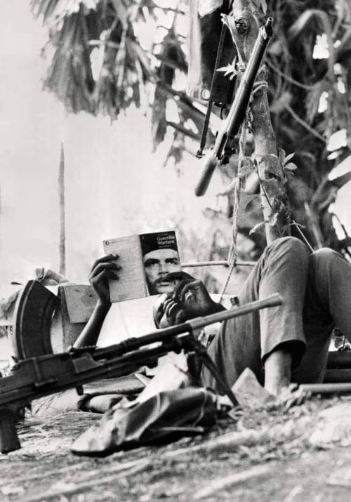 South Sudanese rebel rests and reads Guevara book about guerilla theory in 1971 Nudes &amp; Noises  