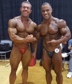 welcometomuscleville:  themuscleworshipdiaries:  American bodybuilders Chris Tuttle and the (always gorgeous!) Mark Dugdale! Loving Tuttle’s bright red, miniscule, shiny as shit posing trunks!   “I finally found a built dude with a tinier basket than