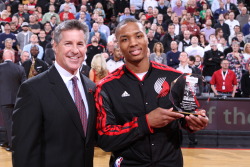 nba:  Damian Lillard of the Portland Trail Blazers accepts the December Kia Rookie of the Month award with Neil Olshey the General Manager of the Portland Trail Blazers prior to the game against the Miami Heat on January 10, 2013 at the Rose Garden Arena