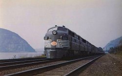 aryburn-trains:    In this fine scene by staff photographer Ed Nowak, the postwar “20th Century Limited” is posed for a publicity photo along the Hudson River near Harmon, New York as Breakneck Mountain looms in the background during September of