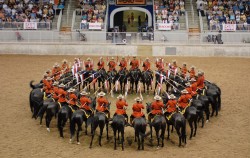 A serge of scarlet (the RCMP Musical Ride equestrian precision drill team create “The Dome” formation)