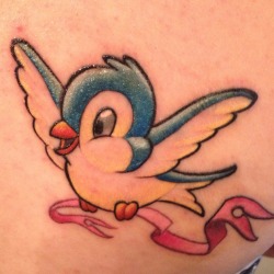 fuckyeahtattoos:  Blue and yellow snow-white style bird, carrying a pink ribbon.   My aunt died of breast cancer, loved birds, and her favorite colors were blue and yellow.   And I love Snow White. :) 