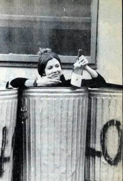 oldschoolcelebrities:Carrie Fisher in the trash with a bottle of wine, 1977