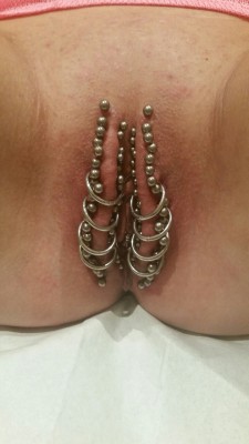  pussymodsgalore Is this a record? I have tried to count, and think she has 35 outer labia piercings with barbells, one at the top and 17 pairs, additionally she has a further 8 outer labia piercings with rings. Her juicy pussy is leaking onto the materia