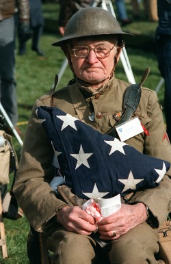 todaysdocument:   Joseph Ambrose, an 86-year-old World War I veteran, watches the dedication day parade for the Vietnam Veterans Memorial. He is holding the flag that covered the casket of his son, who was killed in the Korean War, 11/13/1982  Remembering