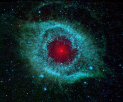 astronomyblog:  Nebula Helix by Spitzer This infrared image from NASA’s Spitzer Space Telescope shows the Helix Nebula.   The nebula, located about 700 light-years away in the constellation Aquarius, belongs to a class of objects called planetary nebulae.