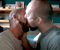 Adult male kiss.