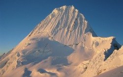 Alpamayo, a peak in the Cordillera Blanca in Peru; a steep (sixty degrees), almost perfect pyramid of ice, one of a number of peaks that compose the Pukarahu massif. Although smaller than many of its neighboring peaks, it is distinguished by its unusual