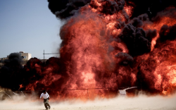 picaet: An Iranian man who was fixing explosives wires run away after setting ablaze 50 tons of drugs seized in recent months in eastern Tehran to mark the International Day Against Drug Abuse and Illicit Trafficking.Picture: Behrouz Mehri