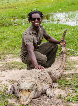 georgequaenoo:  Holding death by the tail? Not likely. Here is a throwback image from one of my assignment trips to Ghana. This was taken in Paga, a small town in northern Ghana on the border of Burkina Faso. Over a hundred crocodiles roam the town and
