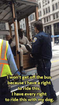 ghettablasta:    Cop forces disabled Black man to get off the cable car (run by SFMTA) because the driver is afraid of his pitbull service dog.   In a viral video shared by San Francisco resident and attorney Gina Tomaselli, a man with a pit bull is seen