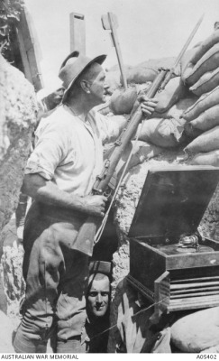 bears-for-the-bear-god: meninroad: An unidentified Australian soldier, probably of the 10th Light Horse, on sentry duty with bayonet attached to his rifle, listening to music playing on the highly prized possession of a gramophone.  Absolute lads 
