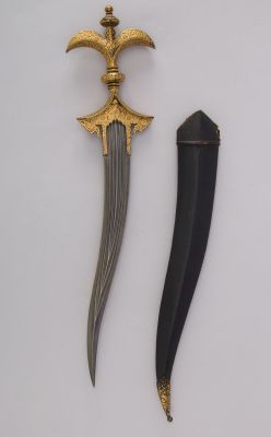 art-of-swords:Chilanum Dagger with SheathDated: 18th centuryCulture: IndianMedium: Iron, gold, leatherMeasurements: H. with sheath 16 3/8 in. (41.6 cm); H. without sheath 15 1/4 in. (38.7 cm); H. of blade 10 13/16 in. (27.5 cm); W. 3 9/16 in. (9 cm);