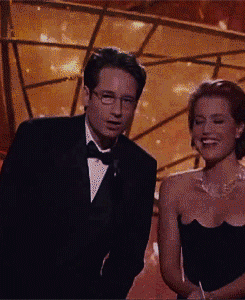 tracylord:  David Duchovny and Gillian Anderson fooling around  presenting Best Actor in a TV Series Comedy> in 1998 [x]