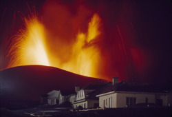 unrar:  Kirkjufell volcano erupting above the town of Vestmannaeyjar, Iceland, Emory Kristof.
