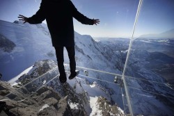 unwisely:   A journalist wore slippers to protect the glass floor of the ‘Step Into the Void’ enclosure at Aiguille du Midi mountain in the French Alps. The structure is a five-sided glass structure installed on the top terrace of the mountain, with