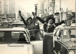 criticalmera:Two women dancing and shouting Black Power slogans amidst the traffic. Cape Town, August 1976. Cape Times photographer.