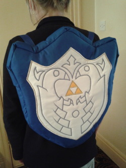 tavington:  Wind Waker Mirror Shield backpack Whew! Finally finished! This was a commission for my good friend Ubermidget as she wanted a backpack too when we hit America :) Link’s Mirror Shield from Wind Waker is one of her favourite designs, so I