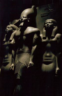 kicker-of-elves:  Pharoah Menkaure flanked by two female deities National Geographic January 1995      Kenneth Garrett 