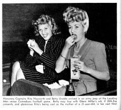 doomsdaypicnic:  Rita Hayworth enjoys a snack with Betty Grable and Grable’s amazing hair.  From Modern Screen April 1943. 
