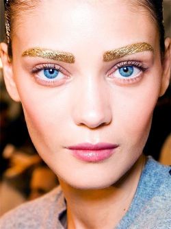 divingintothemakeupworld:  Fave Makeup Looks of 2013:  #4: Dior Spring/Summer 2014 Runway Makeup -On the runway models had gold eyebrows, colorful eyeliner, gold eye shadow and lightly glossed lips.   