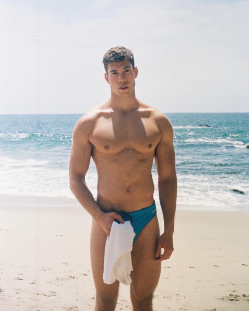 speedoclassics:  Shy hunk on the shore.