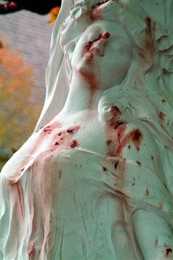 The grave of opera singer Jane Margyl in Batignolles Cemetery, Paris. The appearance of blood stains is from fallen petals.