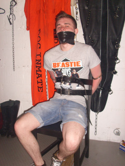 heavy-bondage:  So far, he’d only been cuffed hand and foot, strapped to a chair, gagged and left on his own for an hour…but as he looked around the room and took in all the various forms of bondage and torture equipment which hung from the wall,