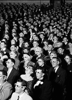 vintagegal:  Formally attired audience sporting 3-D glasses during opening night screening of movie Bwana Devil, the 1st full length, color 3-D motion picture, at the Paramount Theater, Hollywood, CA. 1952 (via) 
