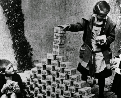  German children play with stacks of money during the hyperinflation period of the Weimar Republic, 1922.  